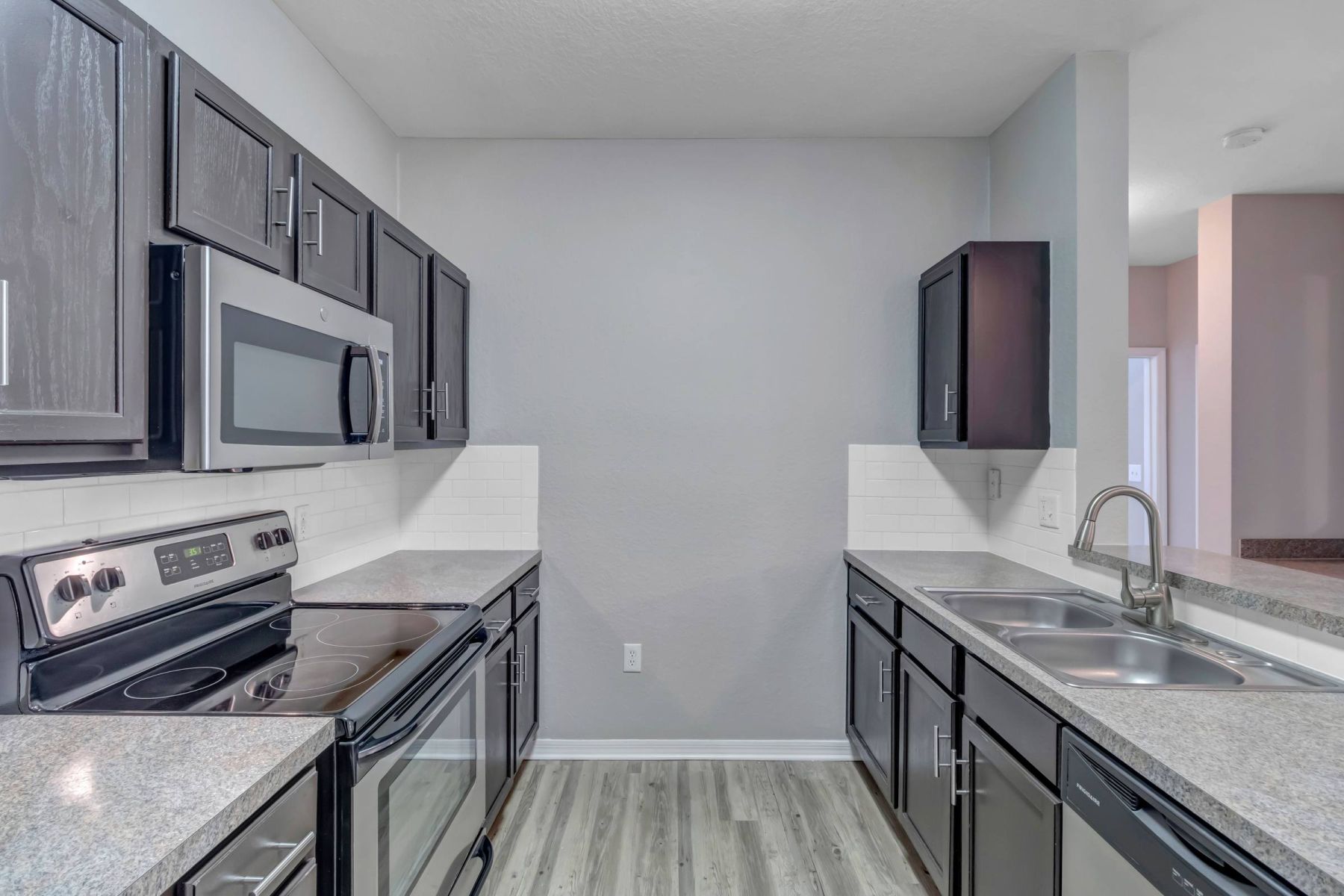 Luxury apartment kitchen with stainless steel appliances, granite countertops, and lots of storage space